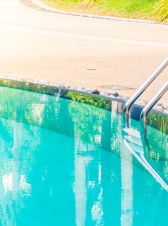 Outdoor swimming pool in hotel resort - Vintage light Filter and Sunflare effect